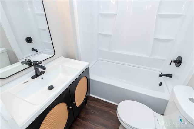 full bathroom with vanity, hardwood / wood-style floors, bathing tub / shower combination, and toilet