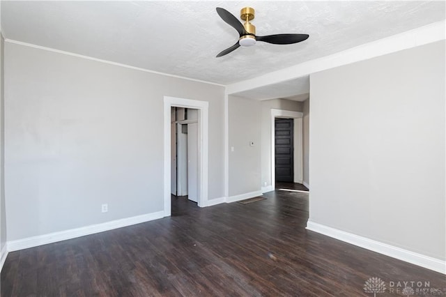 unfurnished room featuring a textured ceiling, ornamental molding, dark hardwood / wood-style floors, and ceiling fan