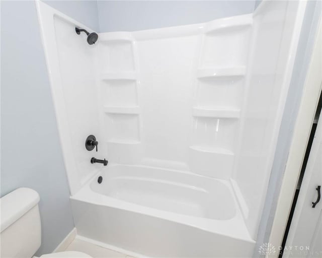 bathroom featuring shower / bathtub combination and toilet