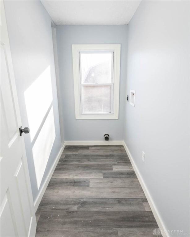 laundry area featuring dark wood-type flooring and hookup for an electric dryer