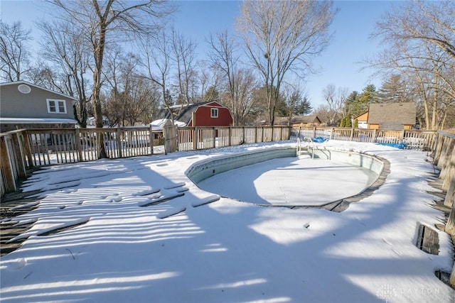 snowy yard featuring an empty pool