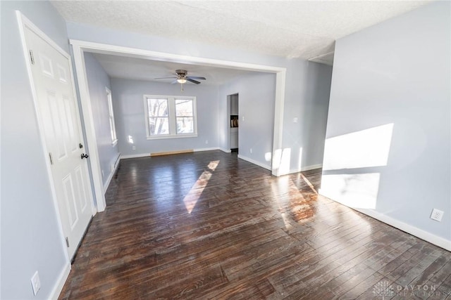 unfurnished room featuring ceiling fan, dark hardwood / wood-style floors, and a textured ceiling