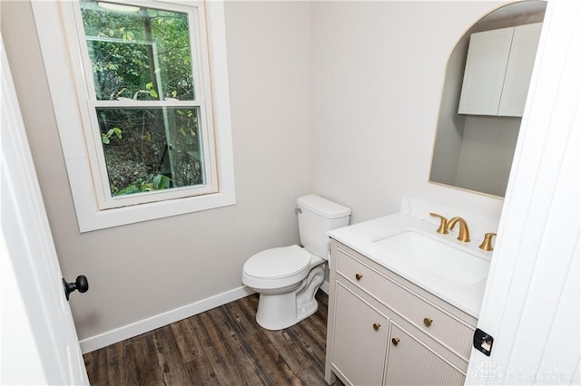 bathroom with vanity, hardwood / wood-style floors, and toilet