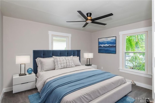 bedroom with dark wood-type flooring and ceiling fan