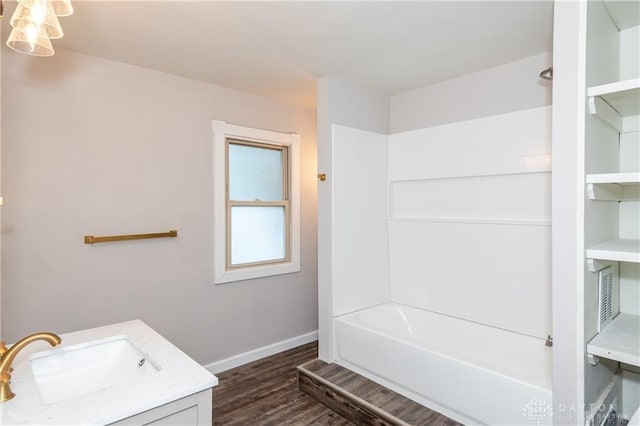 bathroom with vanity, hardwood / wood-style floors, and bathing tub / shower combination