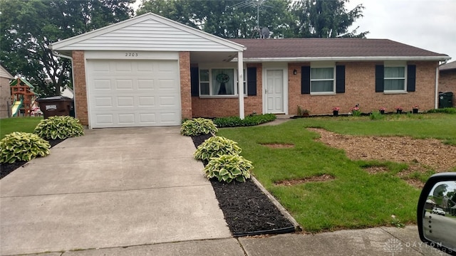 ranch-style house with driveway, brick siding, an attached garage, and a front yard