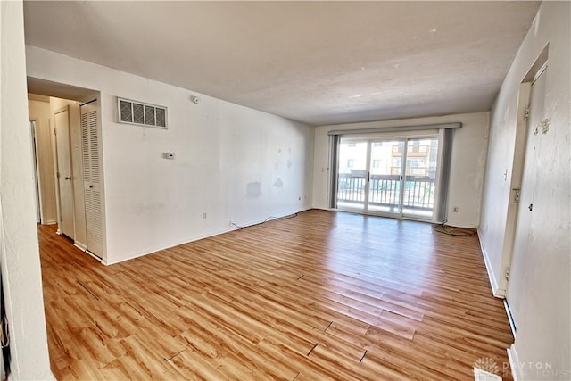 spare room featuring light hardwood / wood-style floors