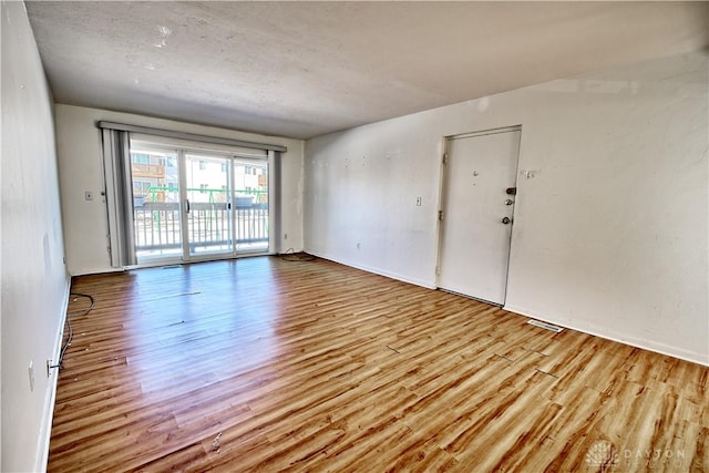 unfurnished room featuring light wood-type flooring