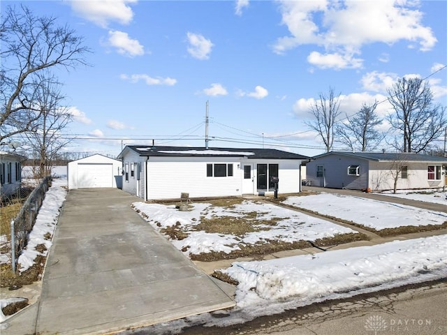 view of front of property with a garage and an outdoor structure