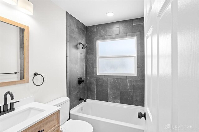 full bathroom with vanity, toilet, and tiled shower / bath combo