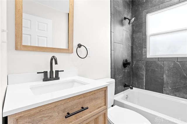 full bathroom with plenty of natural light, toilet, tiled shower / bath combo, and vanity