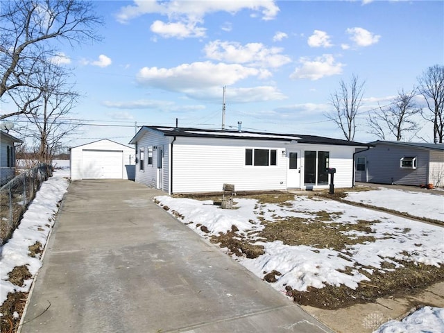 exterior space featuring a garage and an outbuilding