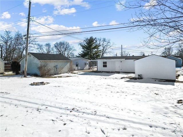 view of snow covered rear of property