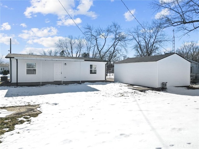 view of snow covered back of property