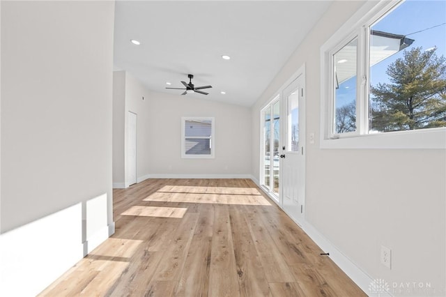 unfurnished living room with ceiling fan, lofted ceiling, and light hardwood / wood-style floors