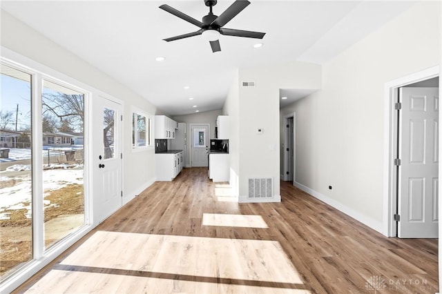 unfurnished living room with lofted ceiling, light hardwood / wood-style flooring, and ceiling fan