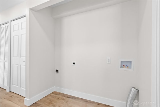 clothes washing area featuring washer hookup, light hardwood / wood-style floors, and hookup for an electric dryer