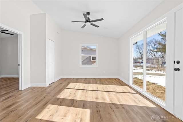 spare room with lofted ceiling, ceiling fan, and light hardwood / wood-style flooring