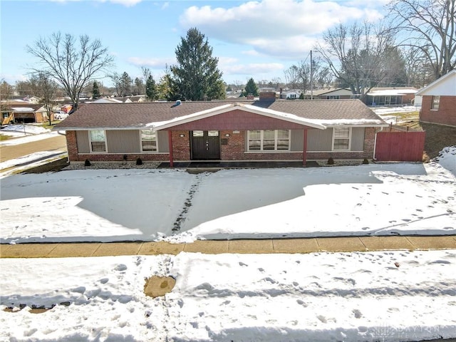 view of snow covered back of property