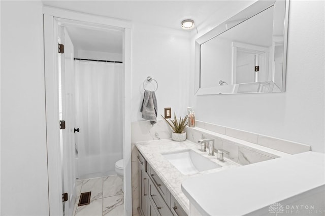 full bathroom with vanity, shower / tub combo with curtain, and toilet