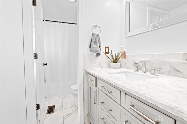 bathroom featuring vanity, toilet, and walk in shower