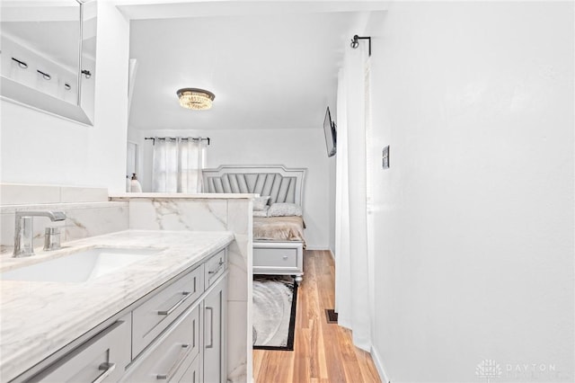 bathroom with vanity and hardwood / wood-style floors