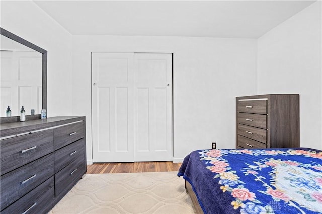 bedroom with a closet and light hardwood / wood-style flooring