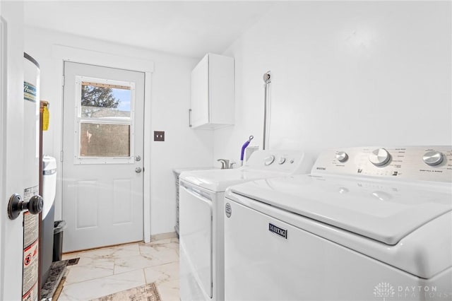 washroom with cabinets and washer and dryer