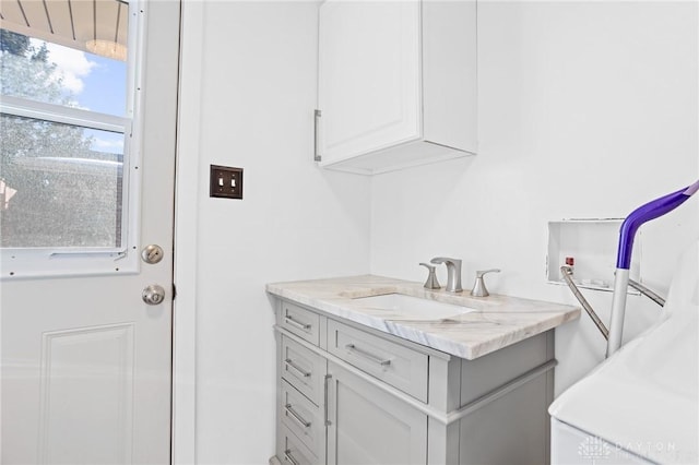 washroom featuring cabinets, hookup for a washing machine, and sink