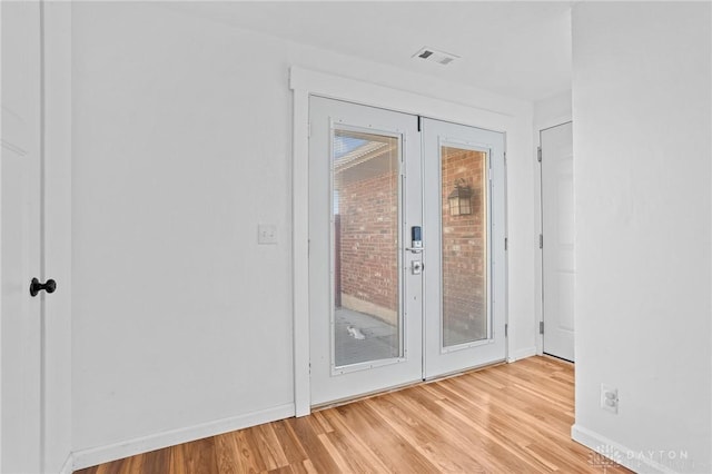 doorway to outside with light hardwood / wood-style floors and french doors