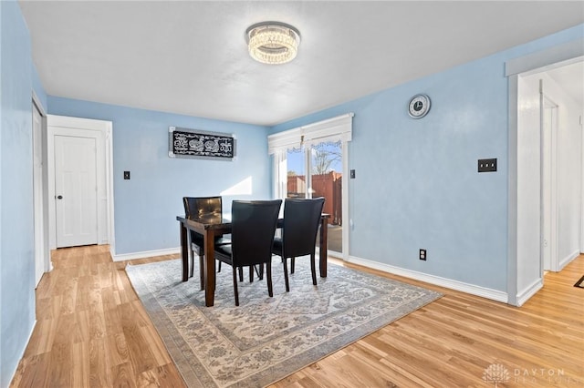 dining space with light wood-type flooring