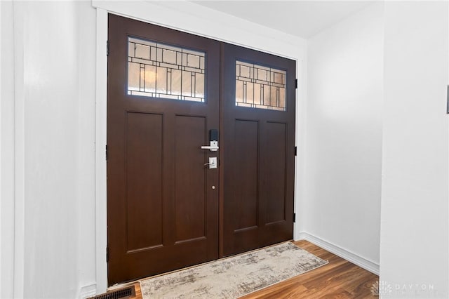 entryway with dark hardwood / wood-style floors