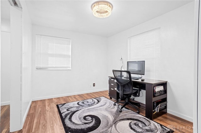 home office with wood-type flooring