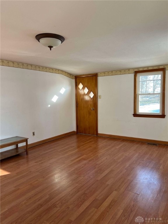 unfurnished room with wood-type flooring