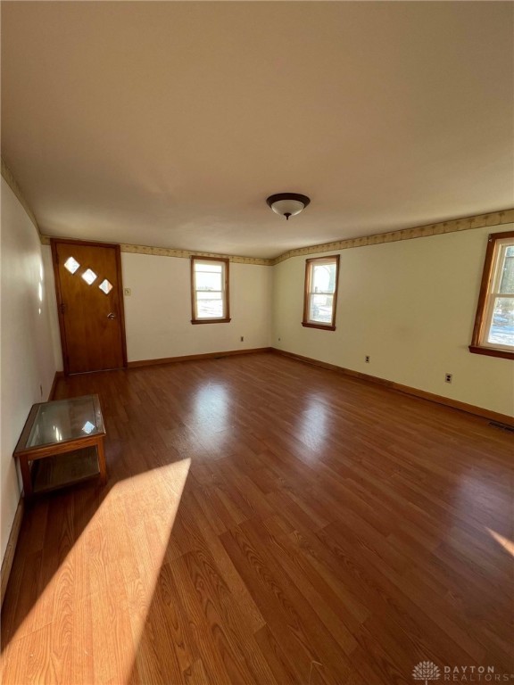 unfurnished living room with hardwood / wood-style flooring