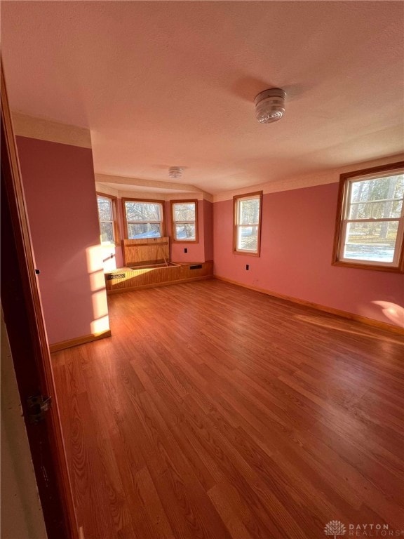 unfurnished living room with hardwood / wood-style flooring and plenty of natural light