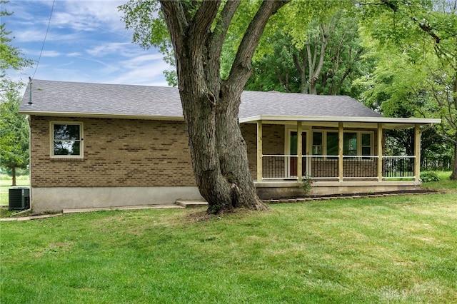 single story home with central AC, a front lawn, and covered porch