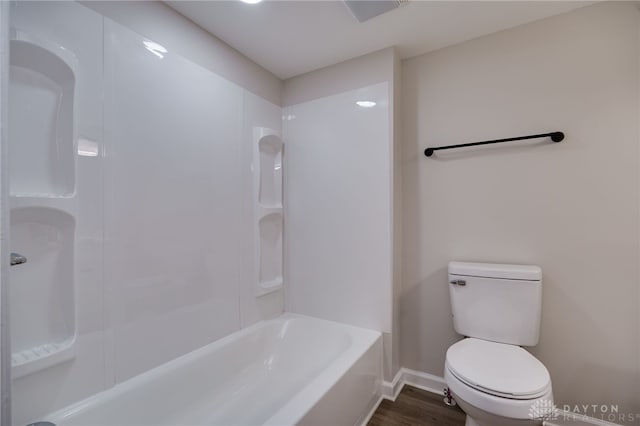 bathroom with baseboards, toilet, and wood finished floors