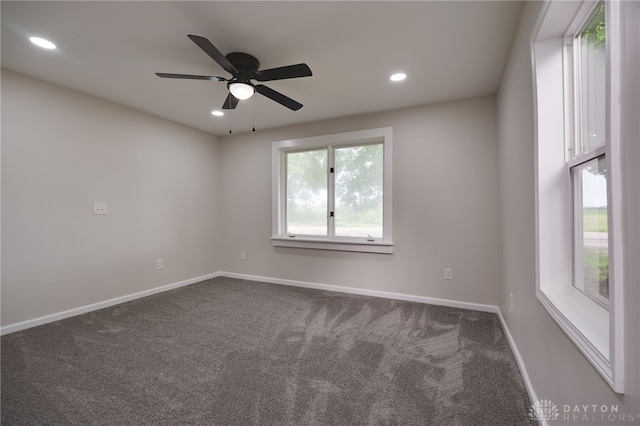 empty room with dark colored carpet, baseboards, ceiling fan, and recessed lighting