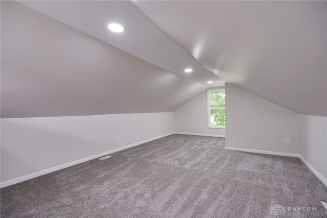 bonus room with lofted ceiling, carpet flooring, recessed lighting, and baseboards