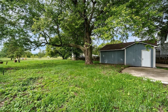 view of yard with an outdoor structure and fence