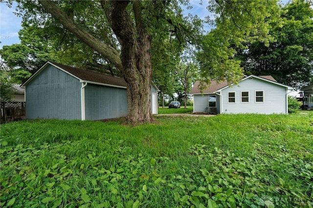 view of yard with an outbuilding and fence