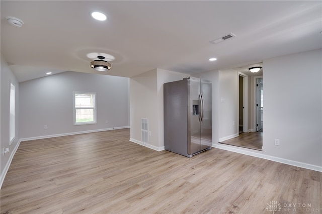 empty room with recessed lighting, light wood-style floors, and visible vents