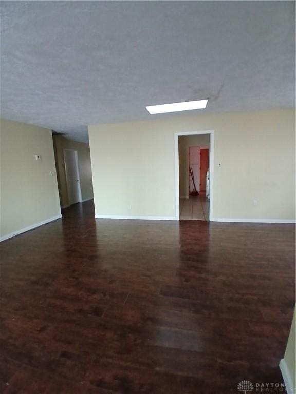 unfurnished room featuring dark hardwood / wood-style flooring