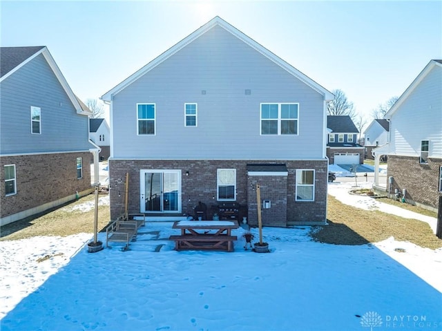 view of snow covered rear of property