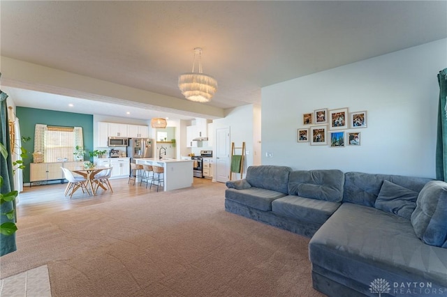 carpeted living room with sink