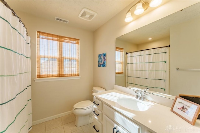 bathroom with vanity, tile patterned floors, and toilet