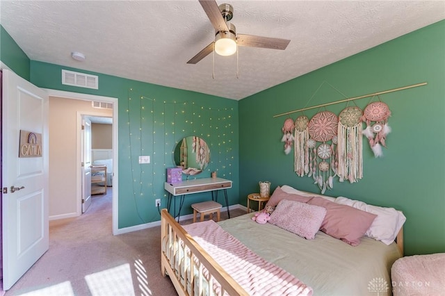 carpeted bedroom with ceiling fan and a textured ceiling