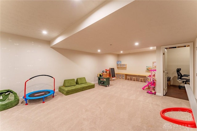 recreation room featuring light colored carpet