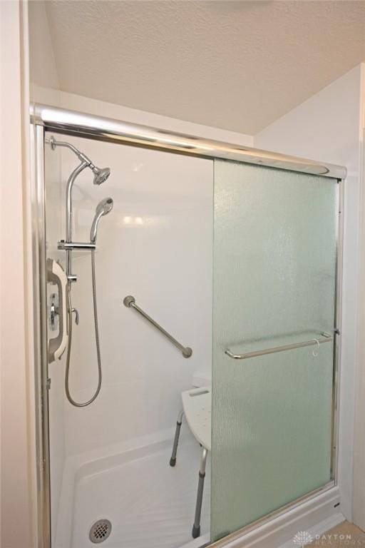 bathroom with a shower with door